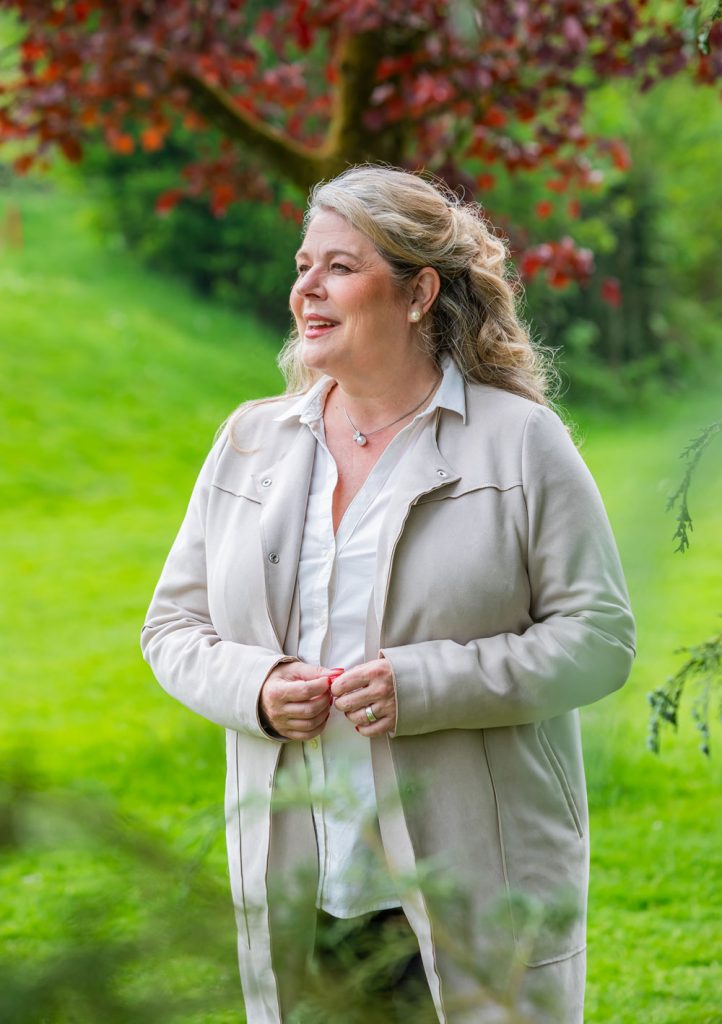 Cordula Ahlers lächelt vor einer grünen Wiese